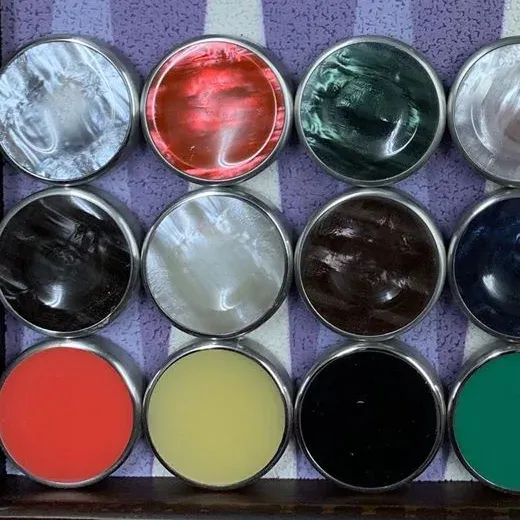 Chrome-rimmed checkers in a range of marbled and solid colours, laid out on a board